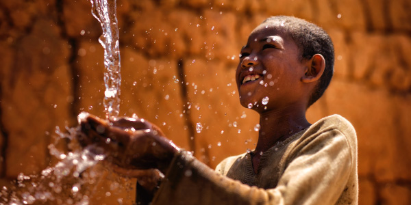 Madagascar boy with water